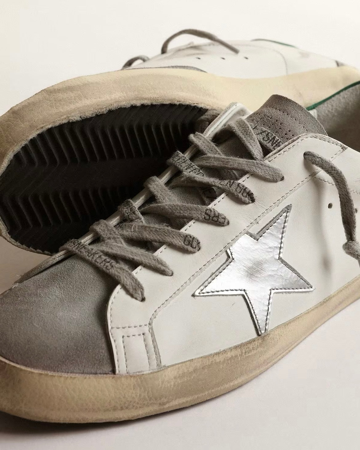Men’s Super-Star in white leather with silver star and green heel tab
