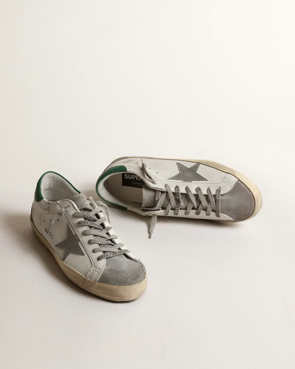 Men’s Super-Star in white leather with silver star and green heel tab